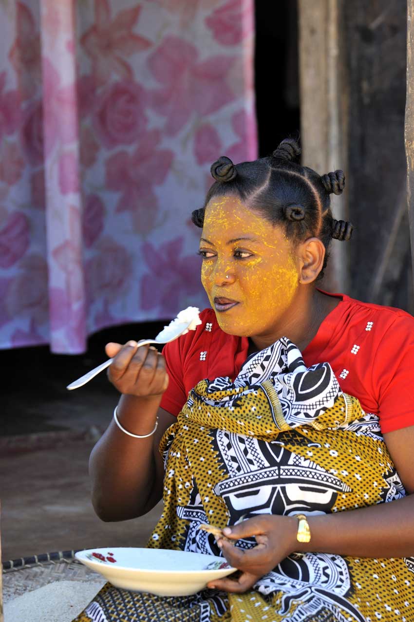 Jeune femme mangeant en tenue locale – Madagascar